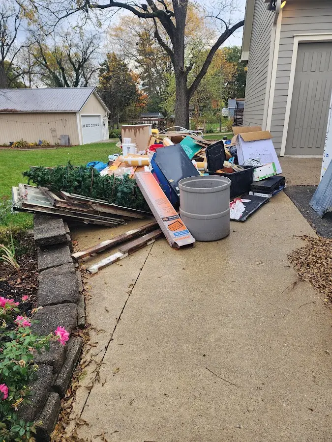 Dumpster being loaded with debris for Roofing Dumpster Rental in St. Robert
